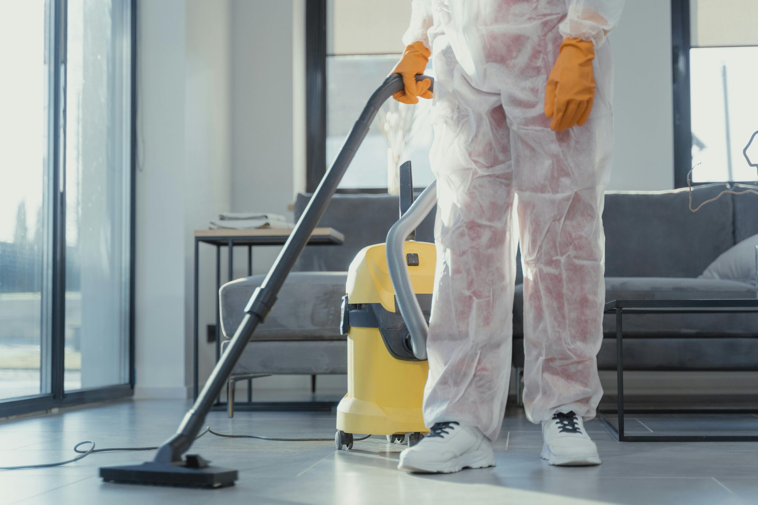 a person vacuuming a floor